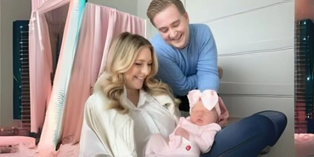 Peter Doocy, Hillary Vaughn with their daughter Bridget Blake Doocy. Bridget is on the lap of her mother Hillary. Peter is watching both of them from top.