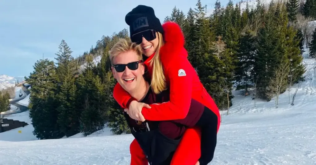 Peter Doocy and Hillary Vaughn on a vacation. Hillary is hugging Peter from the back and there is snow everywhere.